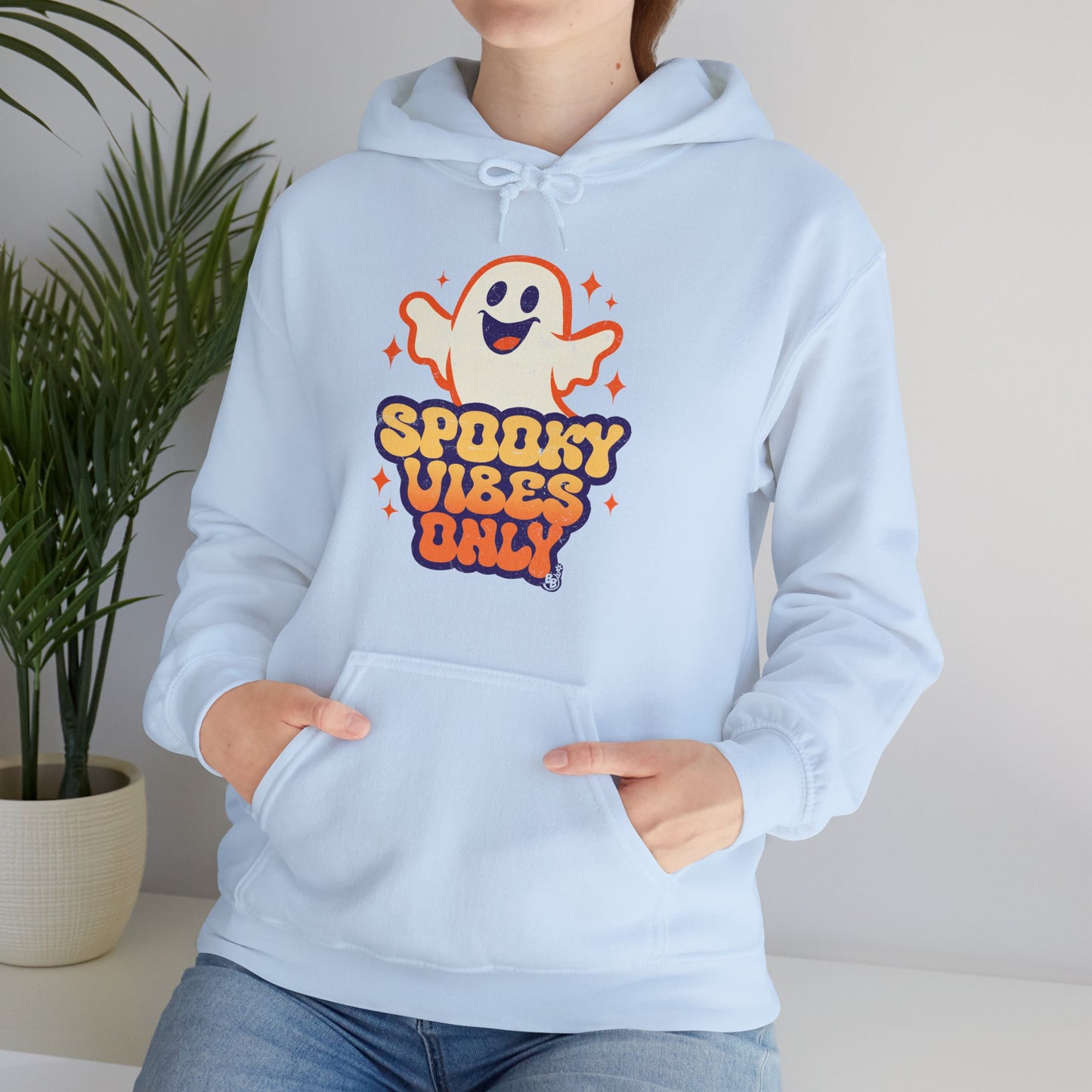 Light blue Spooky Vibes Only Hoodie with funny ghost art worn by a young adult that love vintage halloween cartoon BimBangDesign