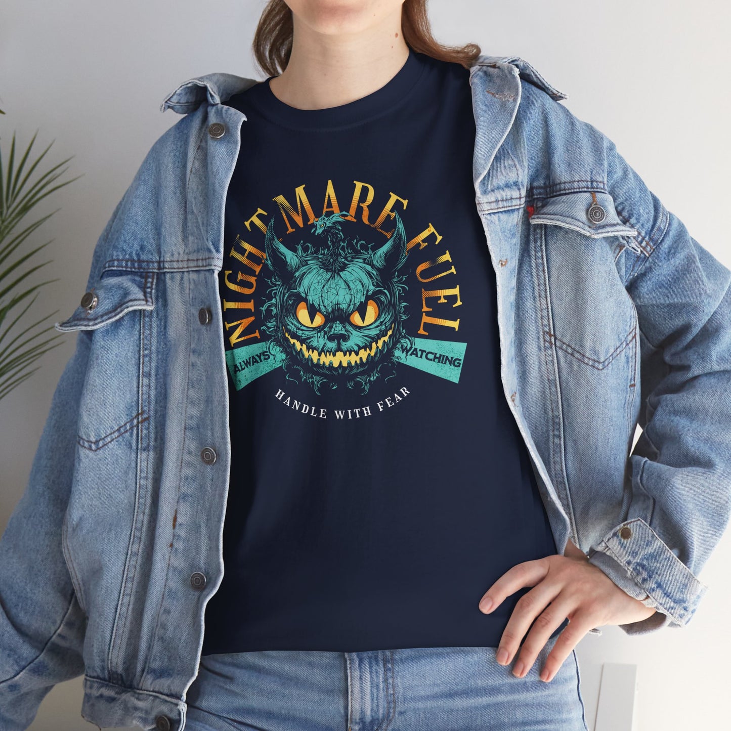 Unisex t-shirt with a creepy-cute monster design and the text “Nightmare Fuel”, worn by a spooky vibe fan, BimBangDesign