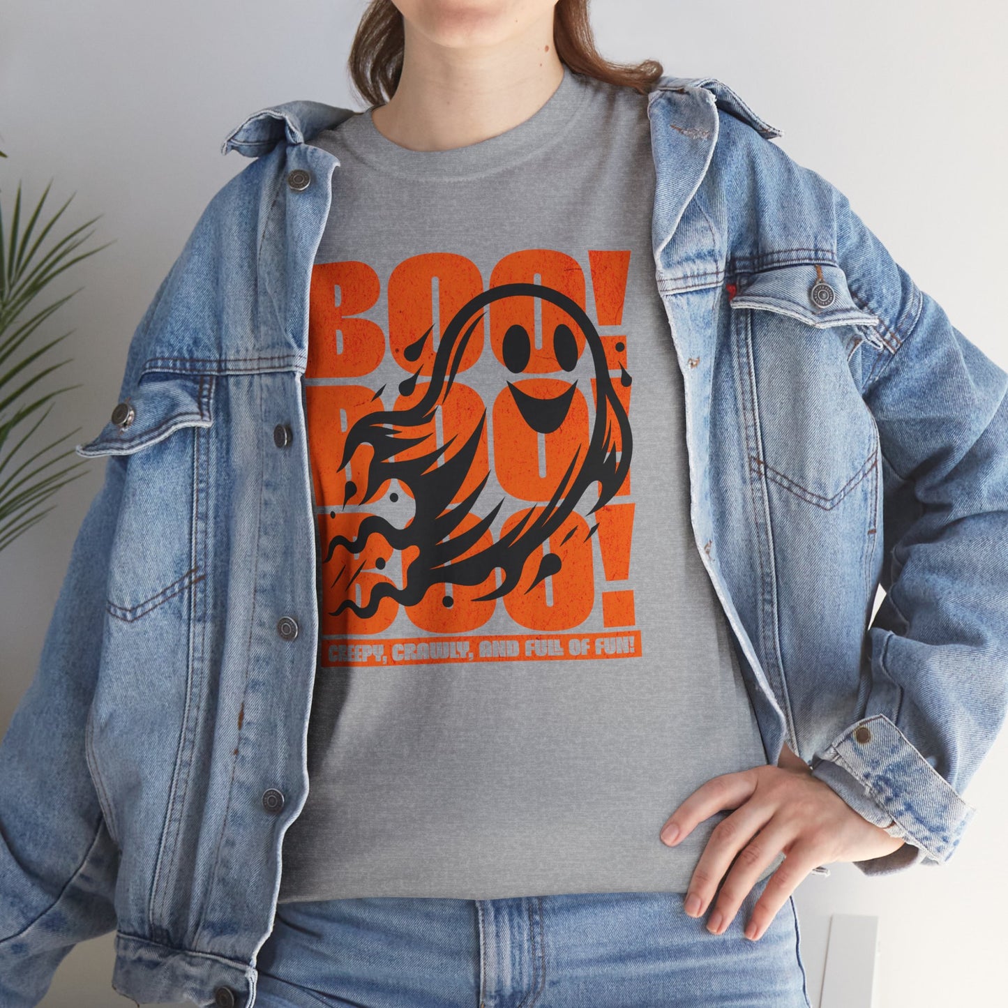 Playful ghost design with triple “Boo” text – fun Halloween unisex t-shirt worn by a spooky season fan, BimBangDesign.