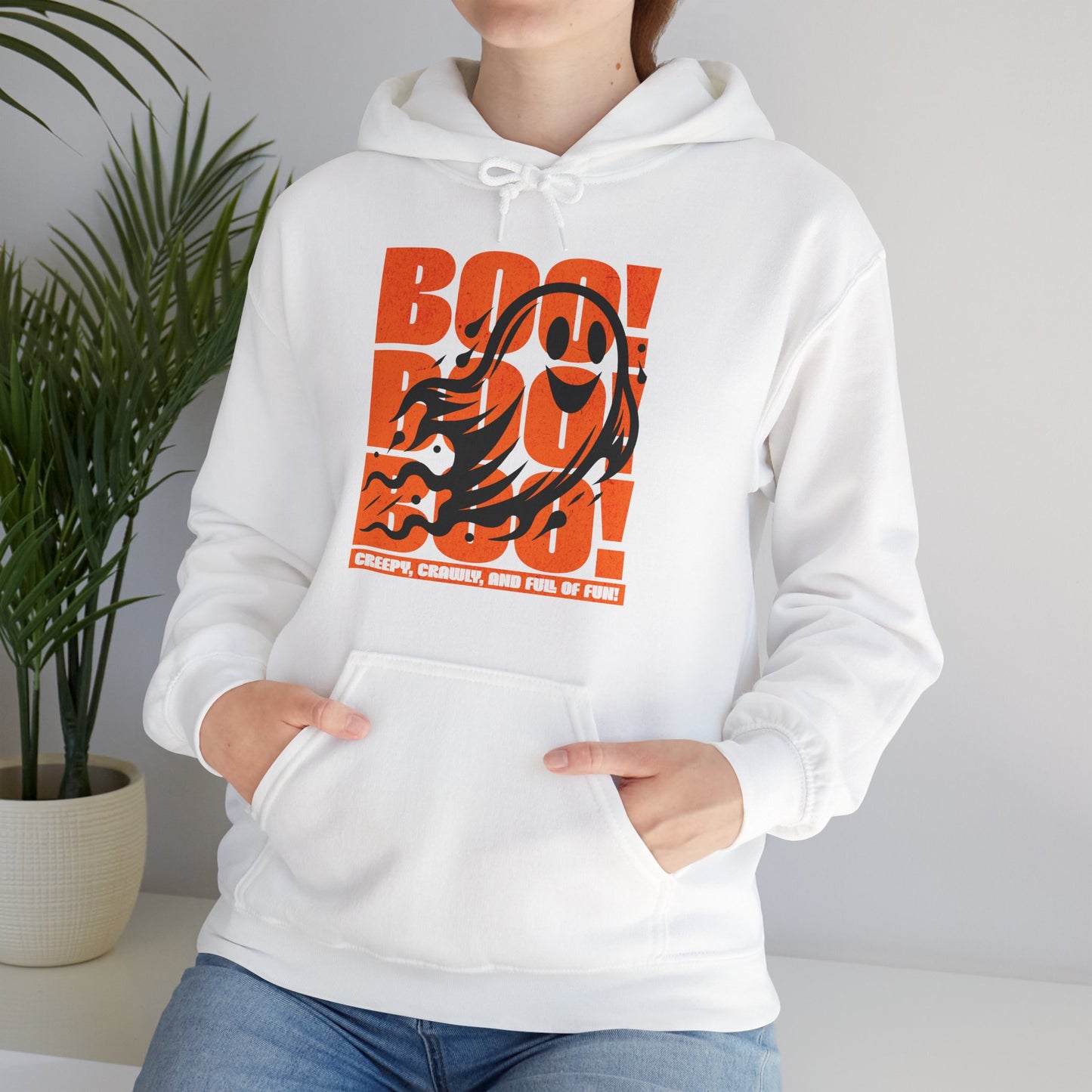 Playful ghost design with triple “Boo” text – fun Halloween unisex hoodie worn by a spooky season fan, by BimBangDesign.