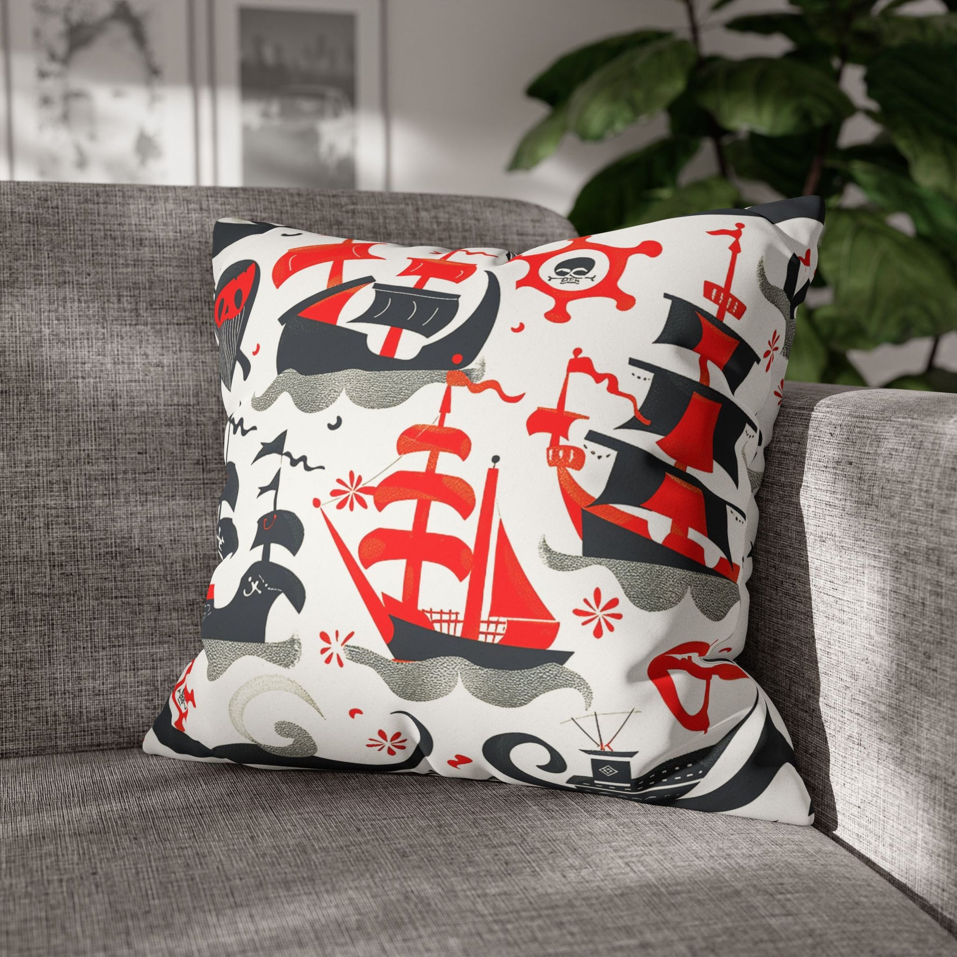 Decorative pillowcase on a sofa printed with charming red, black and grey pirate ships as home decor accessories BimBangDesign