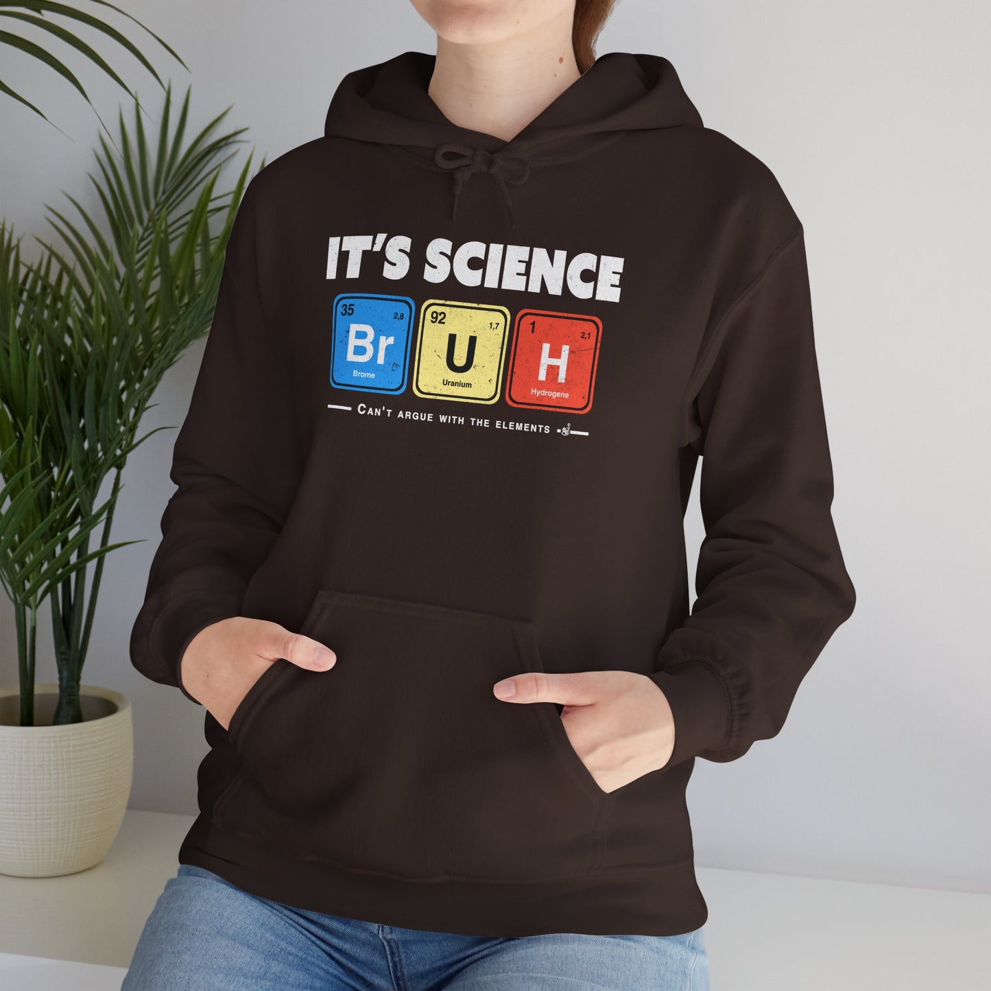 Dark Chocolate Geeky and funny chemistry hoodie with bold white lettering and periodic table squares, worn by a science humour fan. BimBangDesign