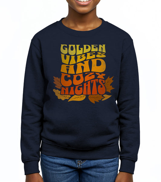 Kids sweatshirt with colorful “Golden Vibes and Cozy Nights” text and autumn leaves illustration. Cozy fall crewneck for children. BimBangDesign