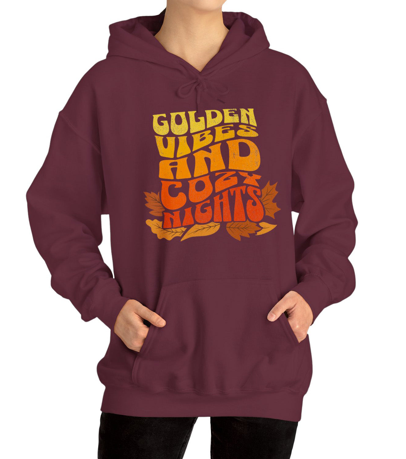 Comfy hoodie with “Golden Vibes and Cozy Nights” text in yellow-to-orange gradient and autumn leafs BimBangDesign
