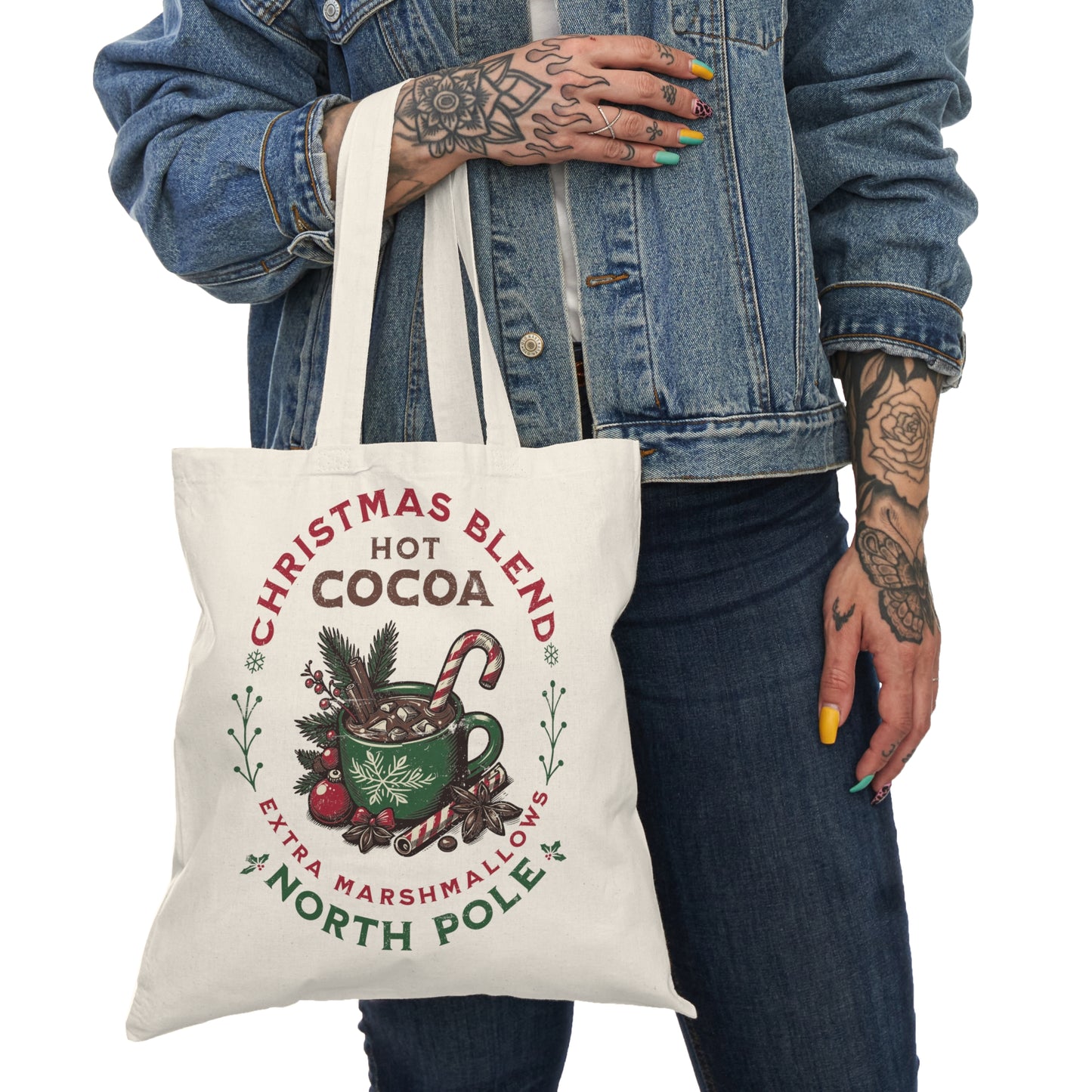 Eco-friendly Christmas tote bag featuring a cozy hot cocoa holiday design. Perfect for shopping, gift carrying, and festive outings. Held by a Christmas entousiast.