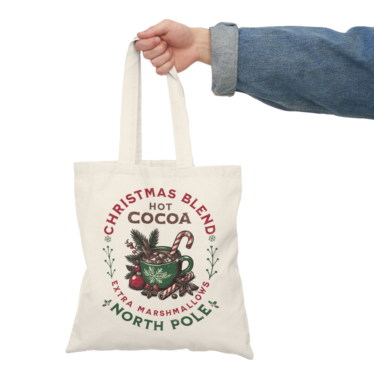 Eco-friendly Christmas tote bag featuring a cozy hot cocoa holiday design. Perfect for shopping, gift carrying, and festive outings. In the hand of a Christmas entousiast.