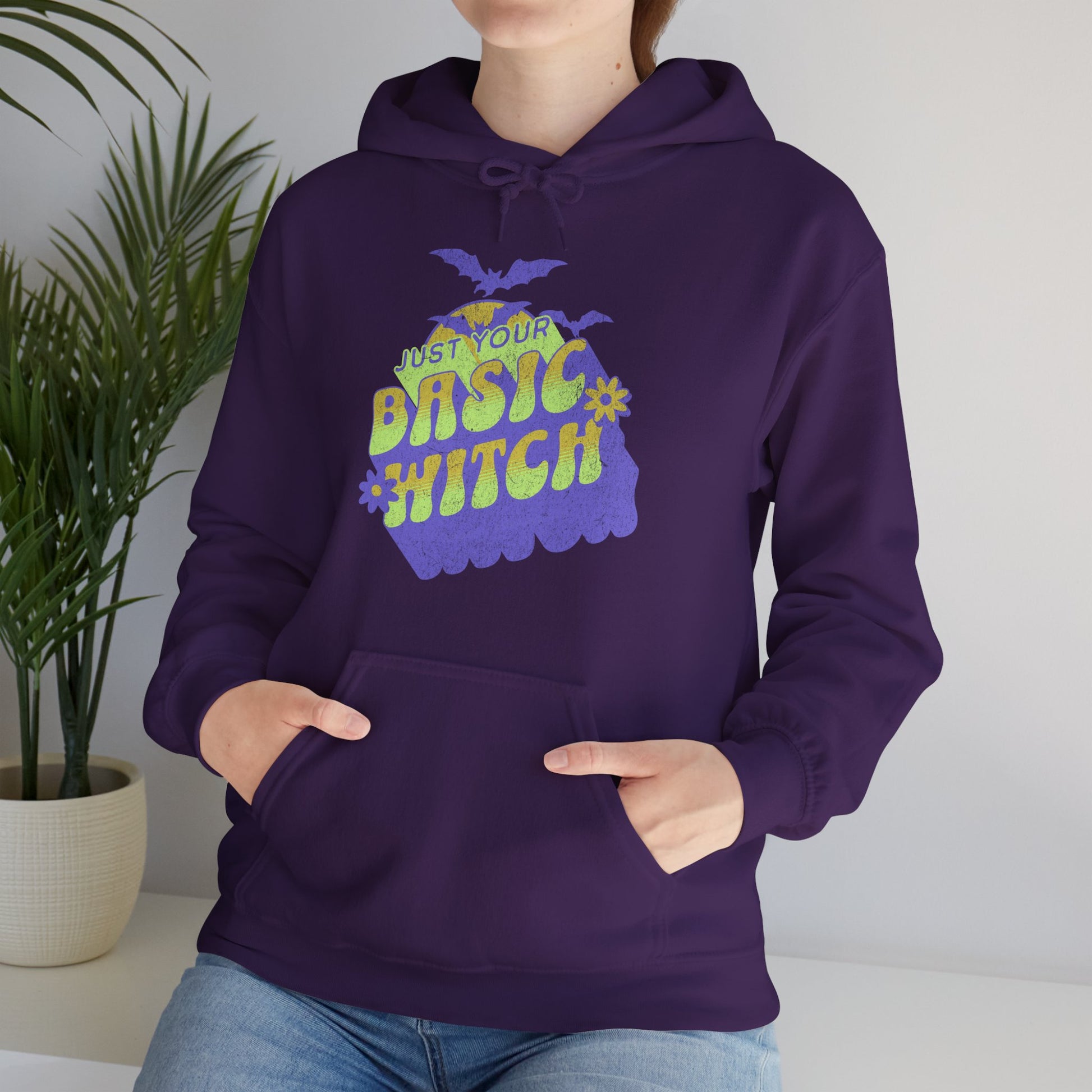 Unisex “Just Your Basic Witch” Halloween hoodie with witchy print — cozy fall fashion worn by a playful spooky season fan. BimBangDesign