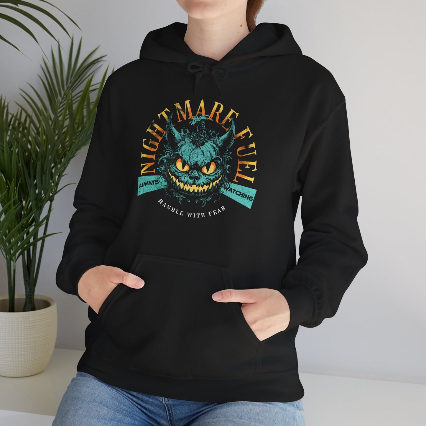 Unisex hoodie with a spooky-cool graphic and the text “Nightmare Fuel” worn by a spooky vibes fan. BimBangDesign