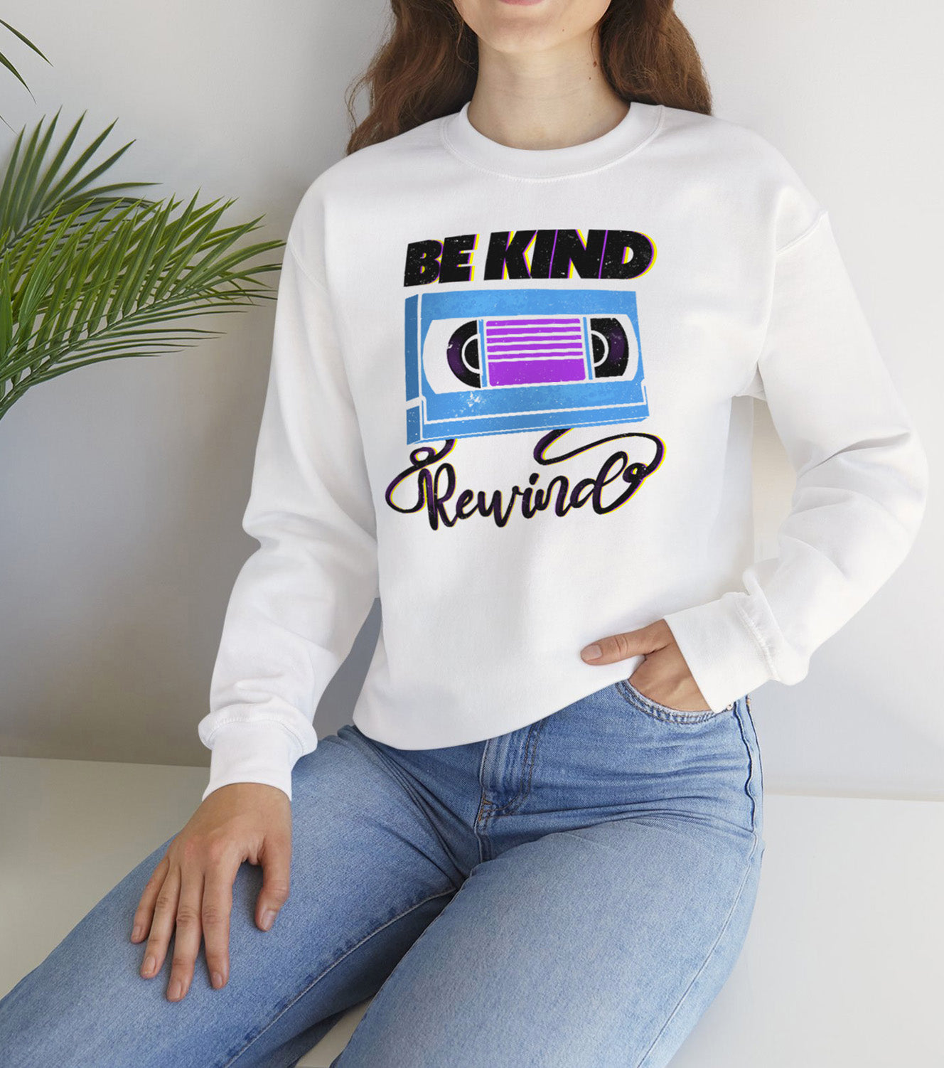 Be Kind Rewind White Sweatshirt, retro typographic style, VHS inspiration worn by a vintage vibes lover BimBangDesign