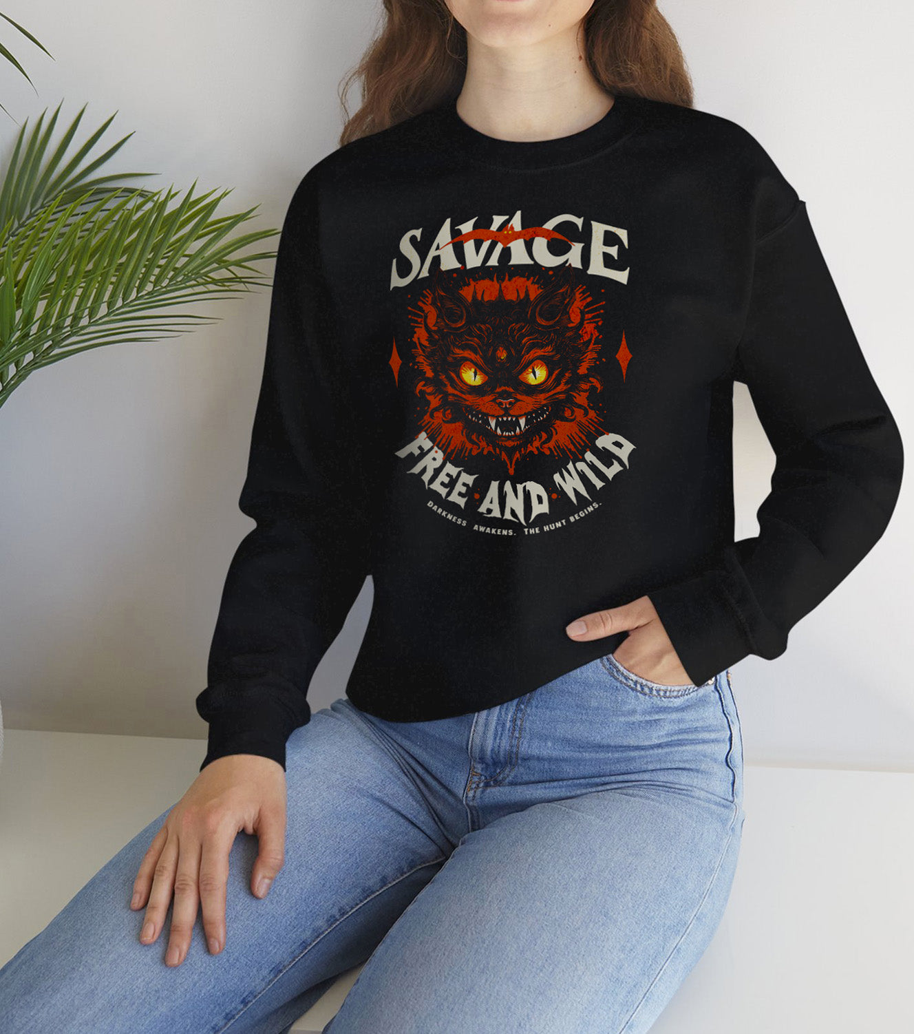 Unisex “Savage – Wild & Free” sweatshirt by BimBangDesign — cozy fleece crewneck with bold wild spirit print, perfect for everyday wear, worn by a spooky vibes fan.