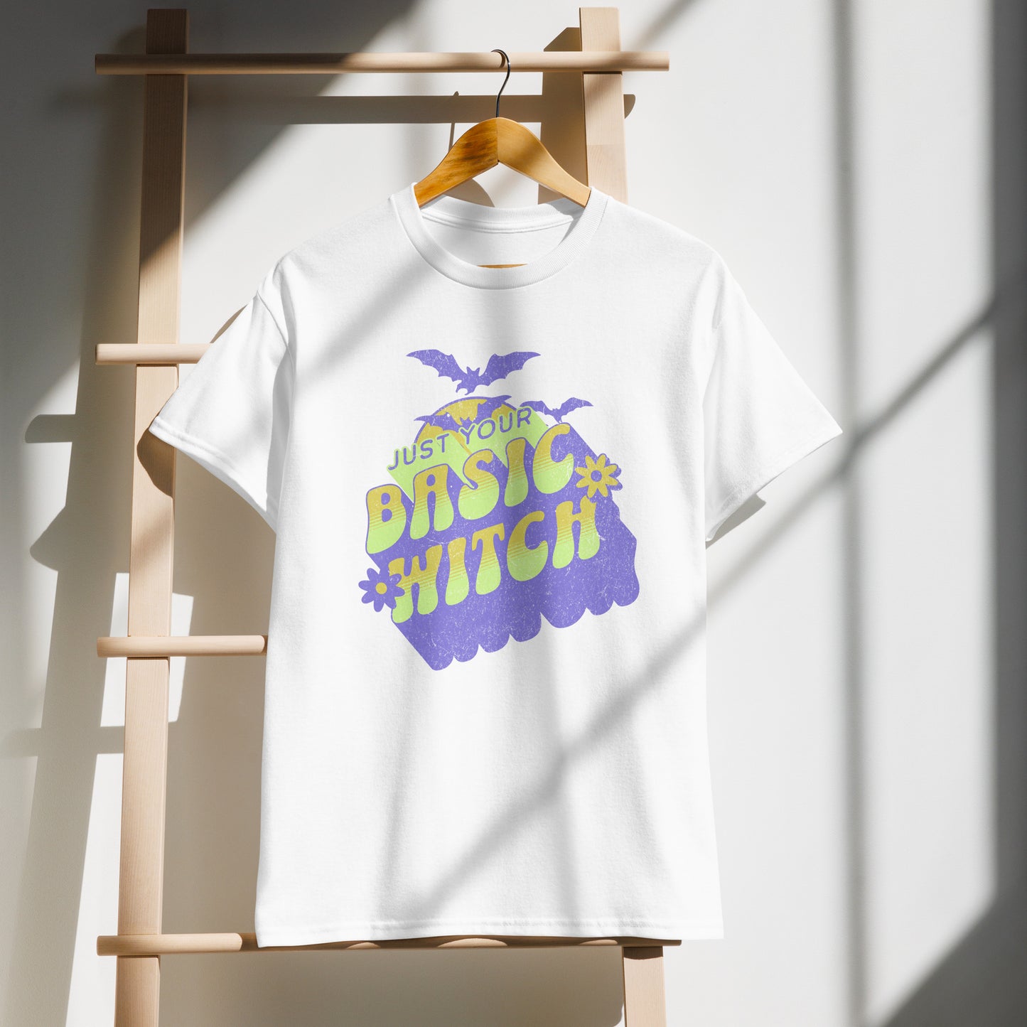 White Unisex t-shirt on demo with “Just Your Basic Witch” print – fun Halloween tee featuring retro witchy vibes, perfect for casual spooky style. BimBangDesign